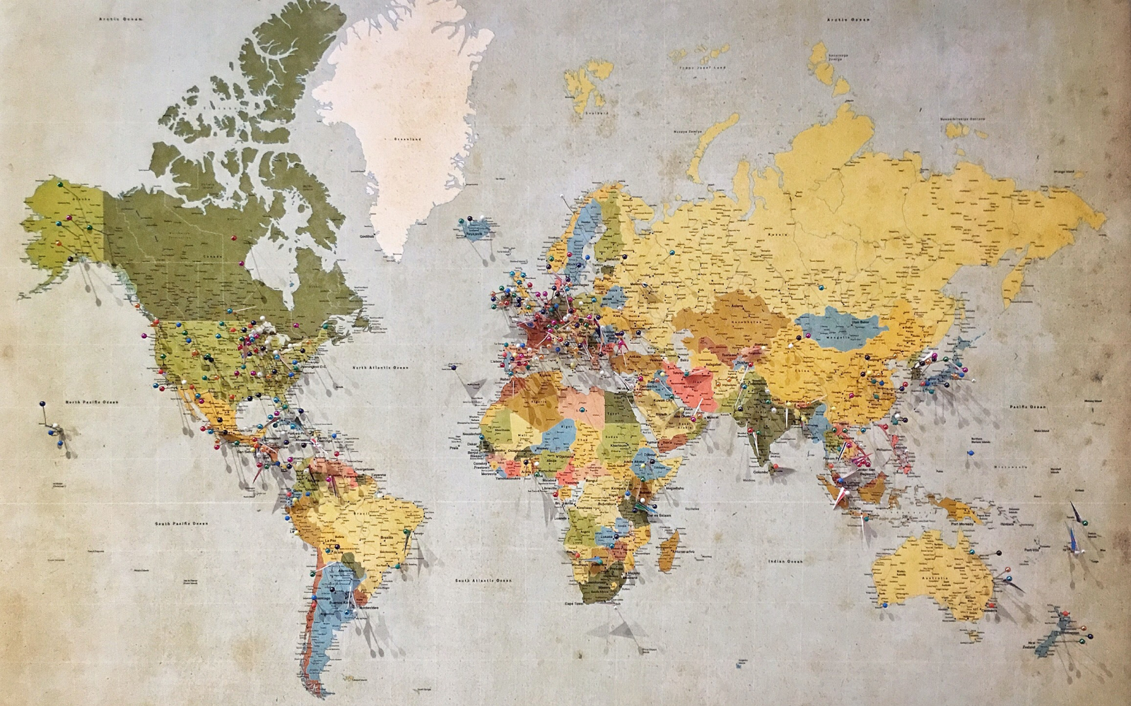 Old-fashionned paper world map with pinned regions